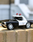 Fekete-fehér retro játék rendőrautó, sheriff felirattal, kültéren téglán