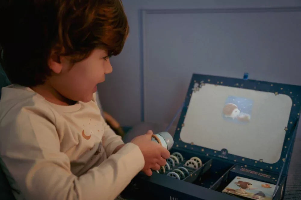 Kisgyermek mesekivetítővel játszik, interaktív tanulójáték használat közben.